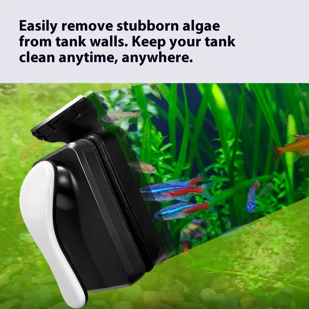 A black and white magnetic aquarium cleaning brush is shown removing algae from tank walls in a green aquatic environment.
