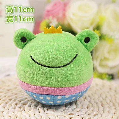 A bright green plush toy shaped like a frog with a yellow crown, resting on a woven surface.