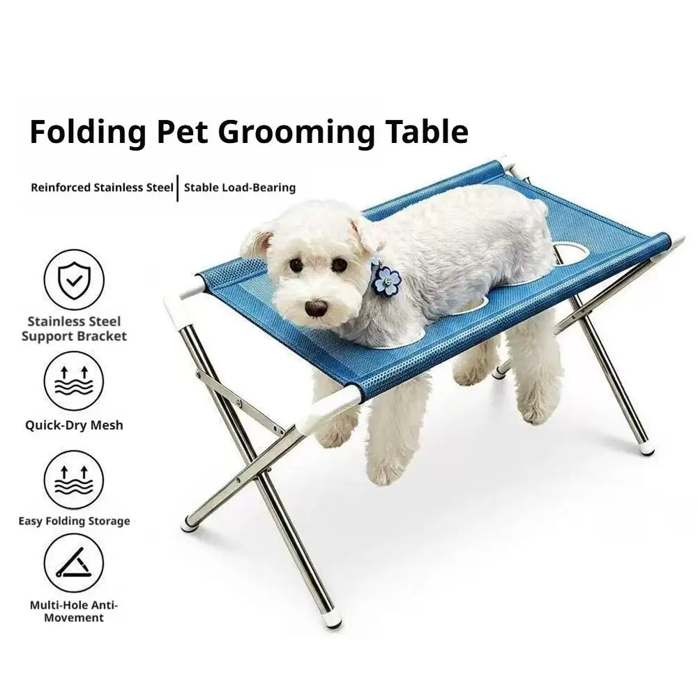 Folding pet grooming table with a blue mesh hammock for bathing and nail trimming
