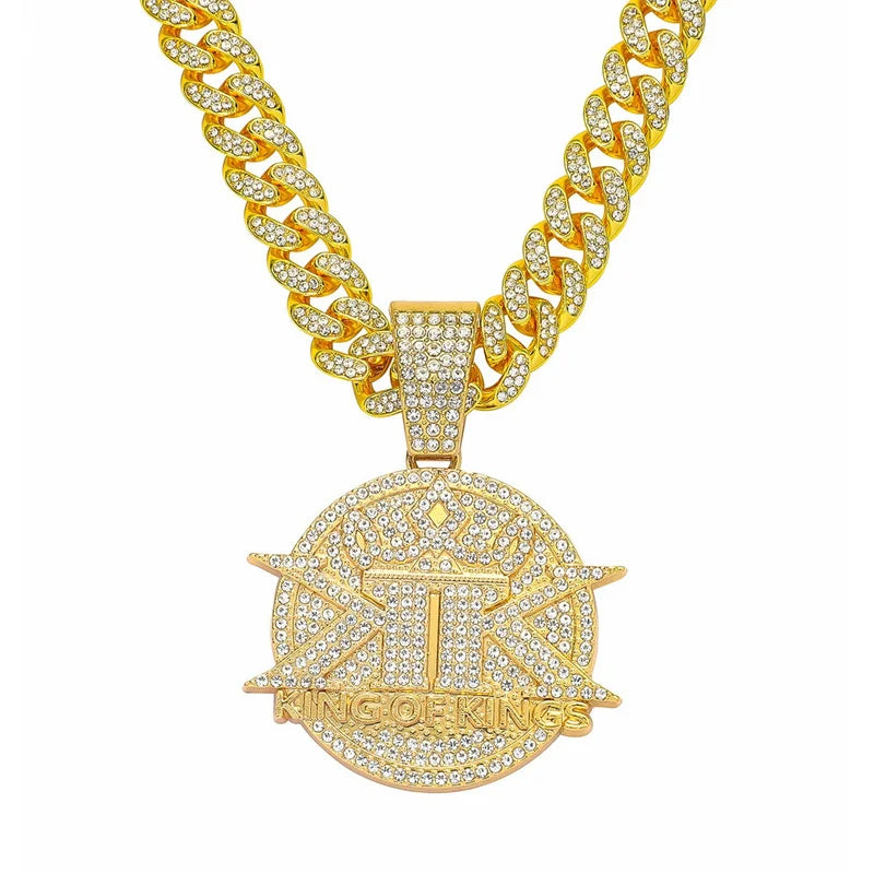 A gold iced out letter and animal pendant Cuban link chain necklace