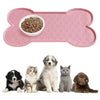 A pink silicone pet feeding mat with a raised edge is shown alongside several cats and a dog.