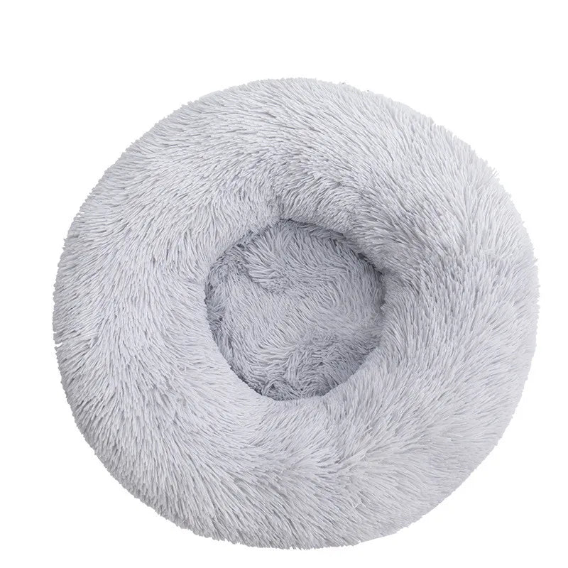 A plush, round pet bed with an anti-slip base for dogs and cats in a light gray color.