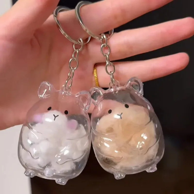 Clear silicone keychain featuring two adorable hamster fur keepsakes with white and beige fluff.