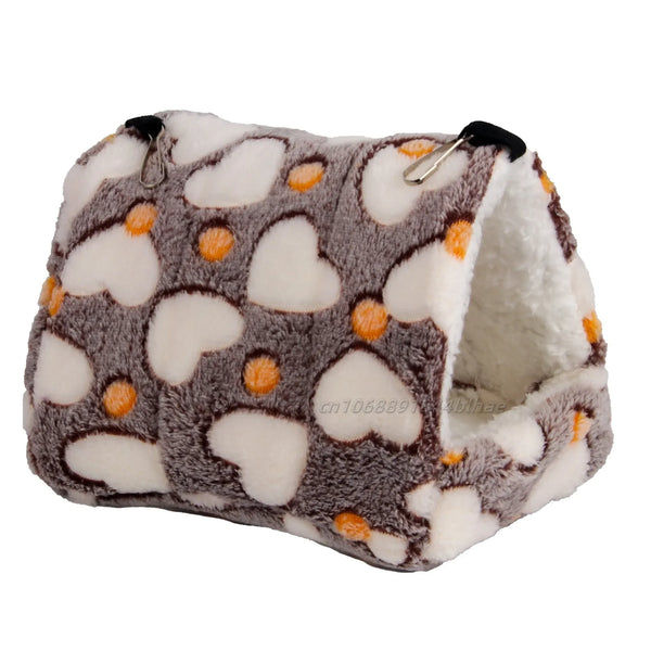 A cozy fleece pet nest bed with a gray and white pattern featuring orange accents.