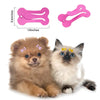 Two fluffy kittens are shown next to pink and yellow hair clips for pet grooming.