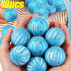 A hand holds a collection of 18 reusable blue and white lint filter balls for laundry.