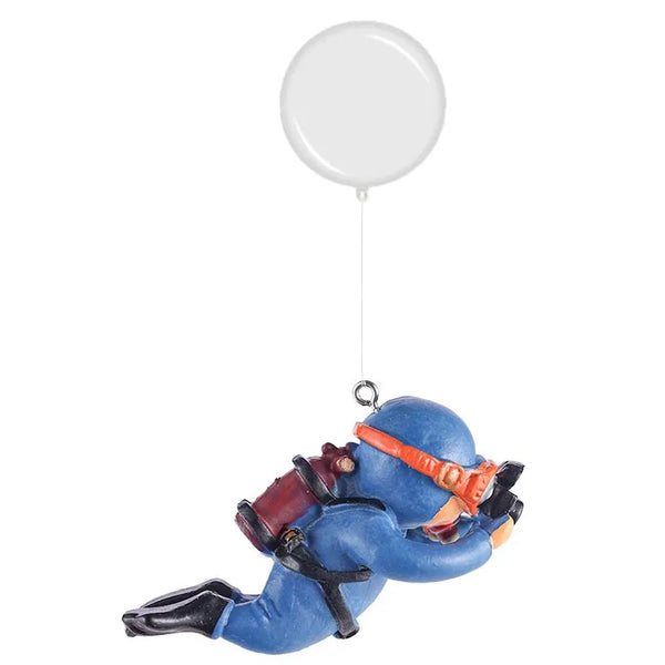 A resin mini diver aquarium ornament in blue and orange is suspended by a white balloon.