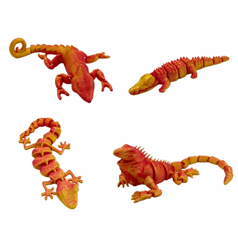A set of three 3D printed reptile figurines including a lizard, chameleon, gecko, and crocodile in shades of orange and yello