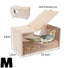 A wooden bird breeding box with a transparent viewing panel and a slanted lid, showing the interior setup.