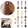 A refillable pet hair keychain with a cat paw charm shown next to a dog, featuring various colored leather and plastic charms