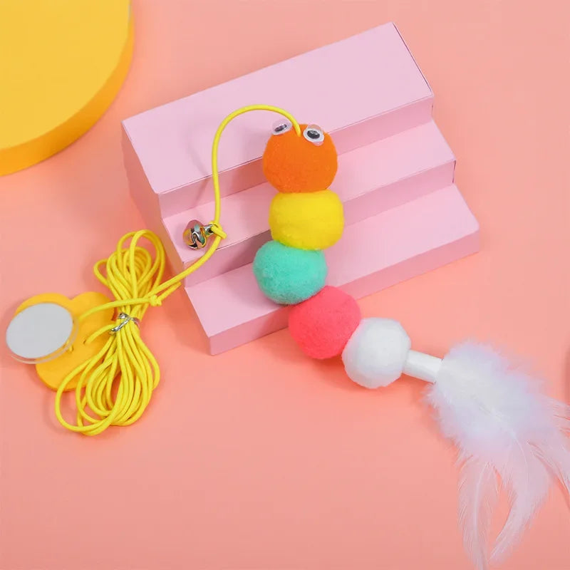 An interactive hanging cat toy featuring colorful, fluffy, and textured components attached to a yellow rope.