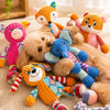 A collection of fluffy orange and pink squeaker plush chew toys for dogs and cats