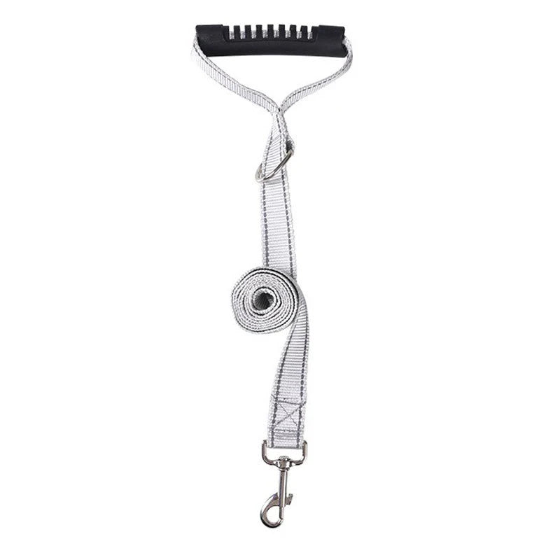A silver reflective dog harness with a black strap and a metal clip.