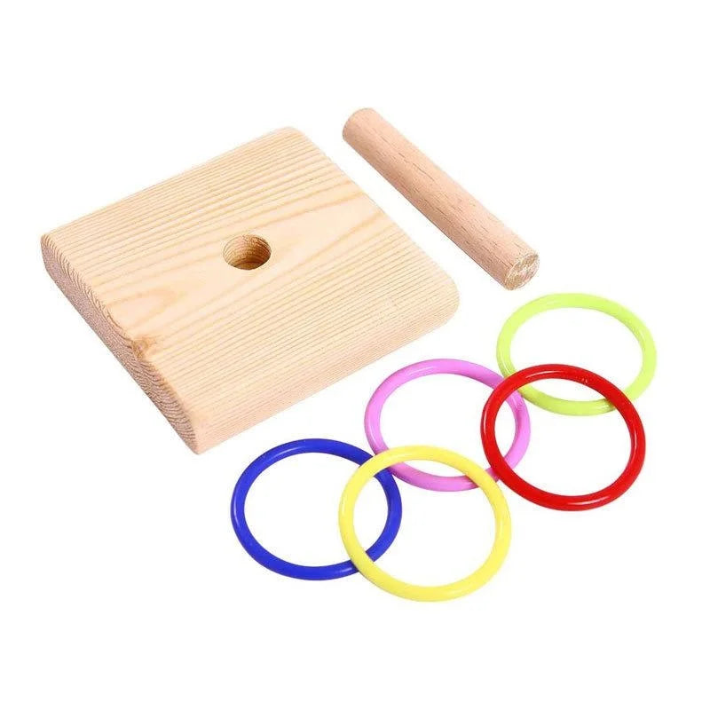 A wooden and plastic ring bird toy with a wooden base and a wooden stick.