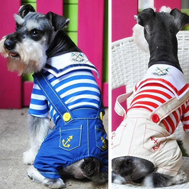 A dog wearing a blue and white striped seaman costume jumpsuit with yellow accents.