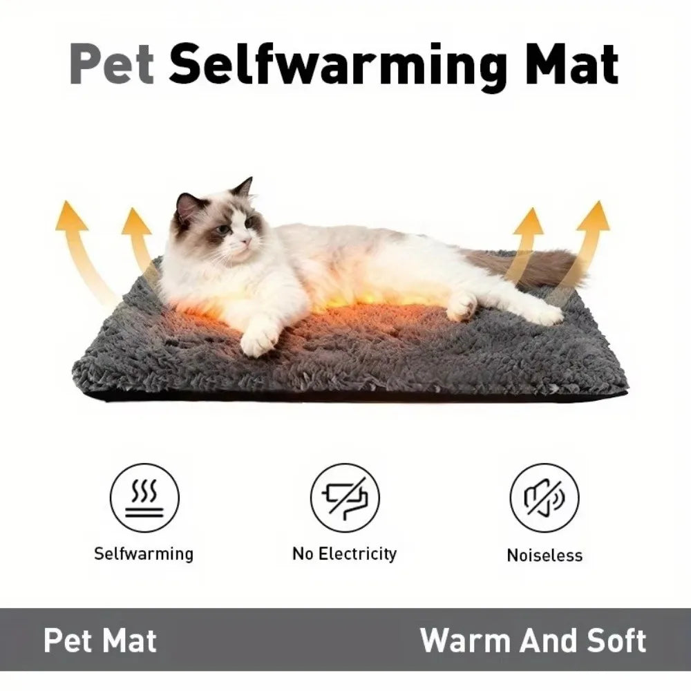 A fluffy white cat is lying on a dark gray self-warming pet mat, demonstrating its warmth and softness.
