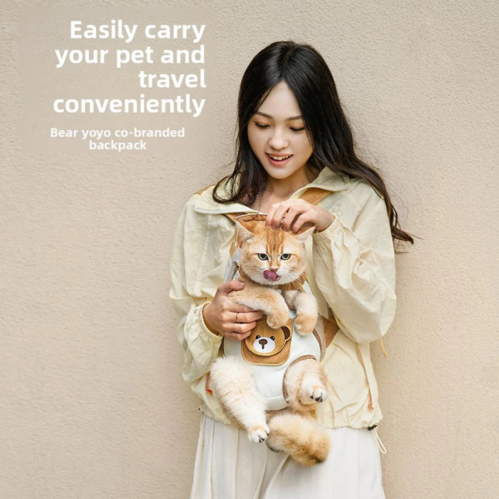 A woman is carrying a fluffy orange cat in a co-branded backpack while standing against a light background.