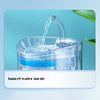 A clear pet water fountain is shown pouring water, demonstrating the faucet water mode.
