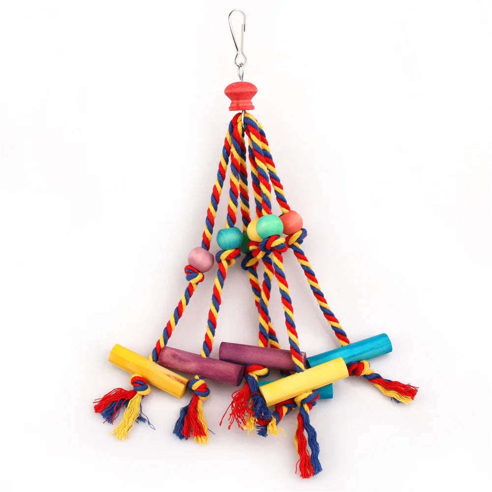A natural wood and cotton rope parrot chewing toy with colorful tassels hanging from a hook.