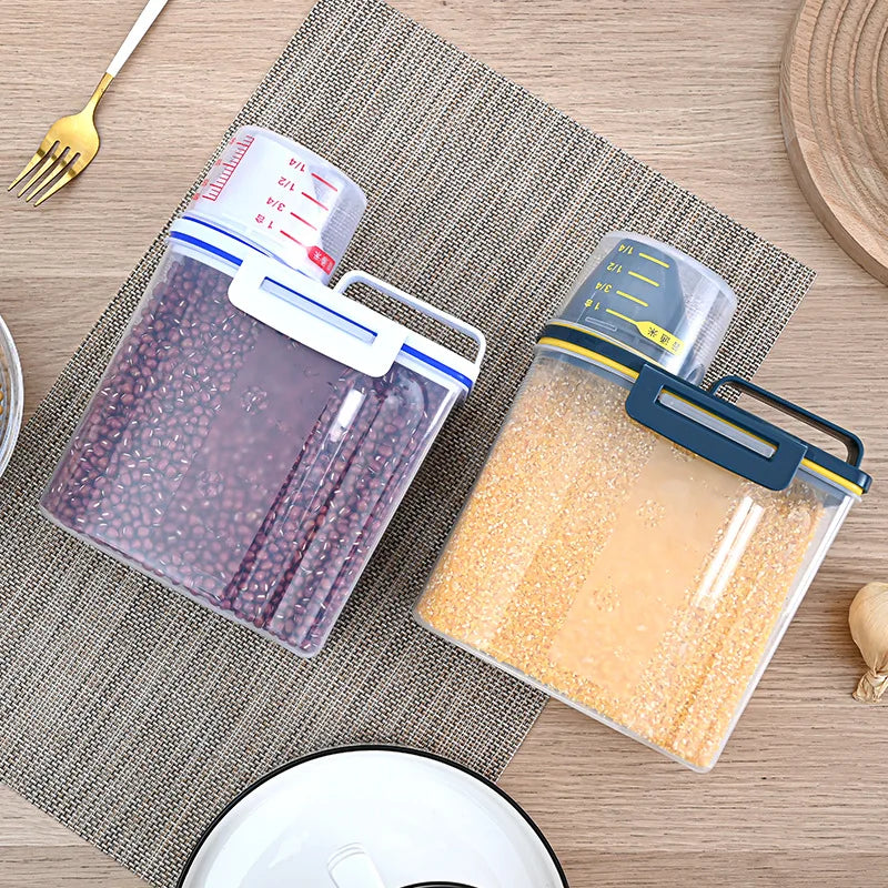 A clear airtight pet food storage container filled with light-colored kibble, next to a measuring scale.