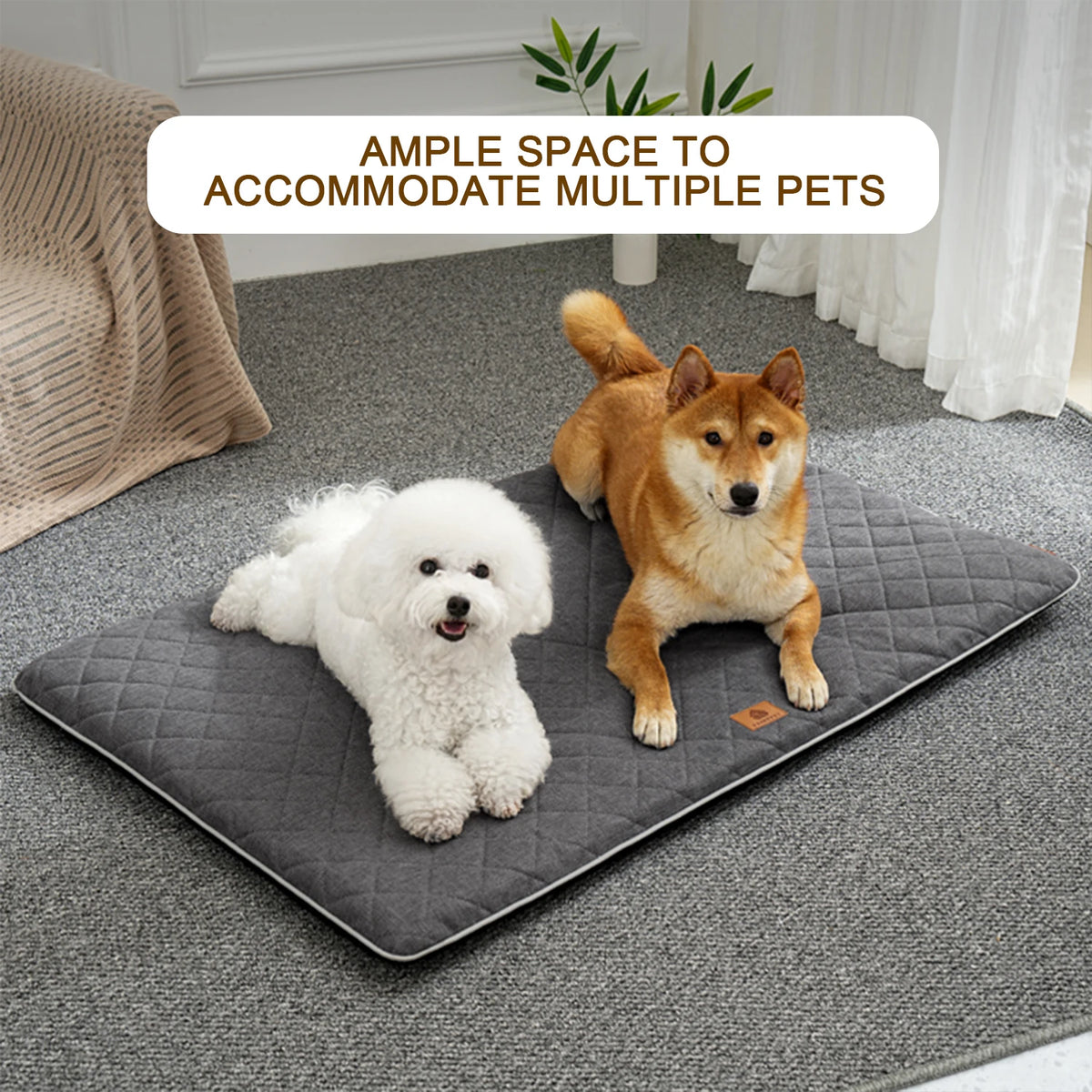 A fluffy white dog is resting on a gray quilted mat indoors.
