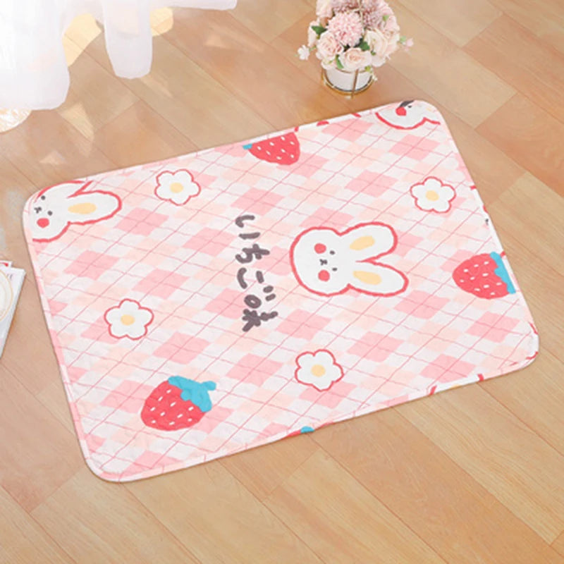 Pink checkered mat featuring cute strawberry and rabbit patterns for pets