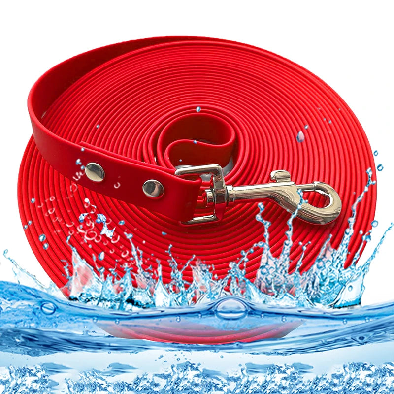 A red heavy-duty waterproof dog leash coiled and splashing in water.
