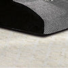 A black memory foam pet ramp with a gray cover is placed on a light-colored carpet.