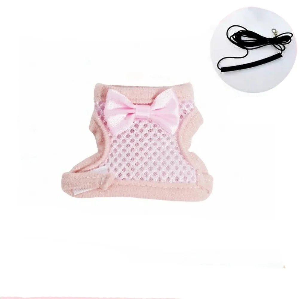 Pink parrot flying harness with a bow and a black cord shown next to the product.