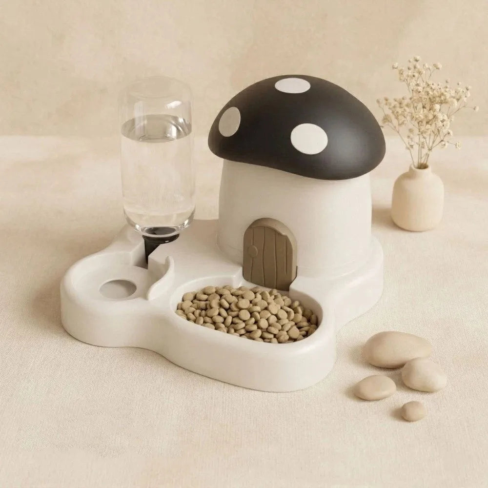 A white mushroom-shaped feeder and water dispenser with a black spotted cap, next to a glass of water and some pebbles.