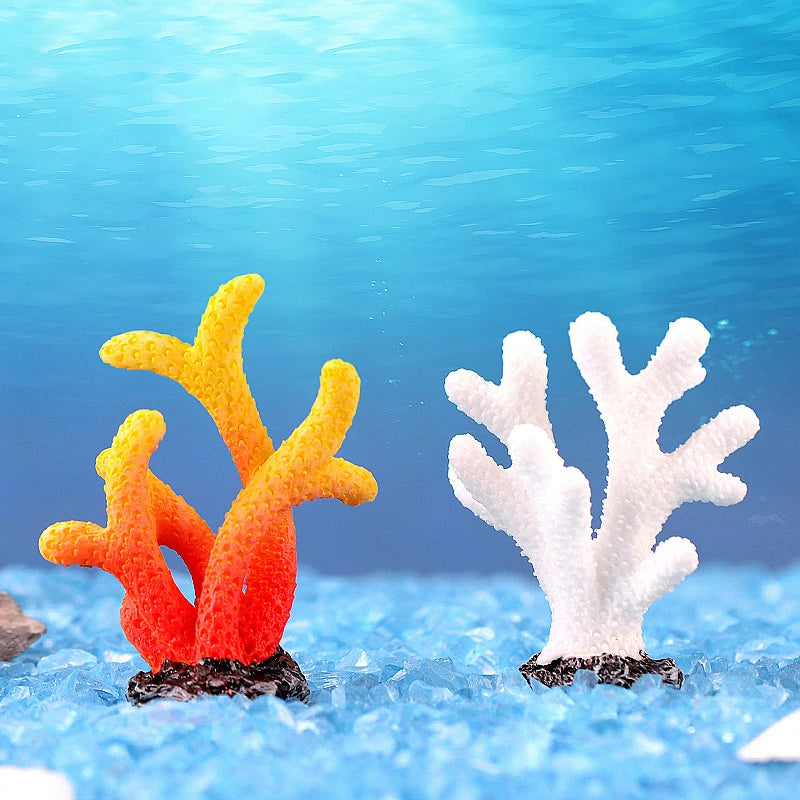 A white coral decoration and an orange coral decoration are visible underwater.