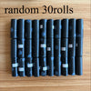 A row of thirty black leak-proof dog waste bags in rolls is displayed on a wooden surface.