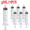 A set of seven 5ml liquid dispensing syringes with graduated markings and tips.