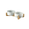 A set of two marbled ceramic pet bowls with a wooden stand.
