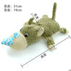 A light green crocheted plush toy resembling a donkey or horse head with a striped muzzle and ears.