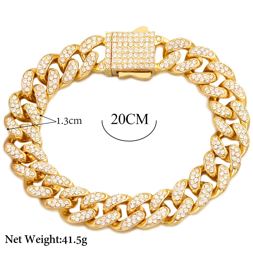 A gold-toned Cuban link bracelet iced out with rhinestones and featuring a square clasp.