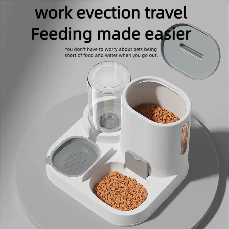 A white gravity cat feeder and water dispenser set with food and water bowls shown on a light gray surface.