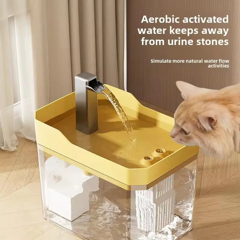A yellow automatic cat water fountain with a silver spout is shown in a clear glass container.