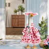 A cute pink strawberry-themed outfit for a goose, displayed outdoors.