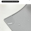 A close-up view of a gray silicone pet feeding mat with raised dots designed to prevent water stains and spills.