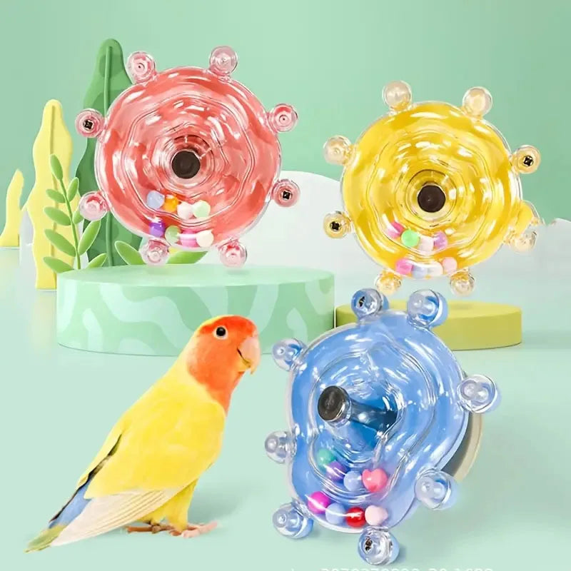Buntes interaktives rotierendes Futterspender für Papageien mit rosa, gelben und blauen Designs.