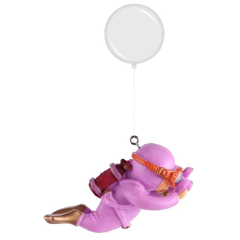 A purple resin mini diver aquarium ornament with gold accents is suspended by a white balloon.