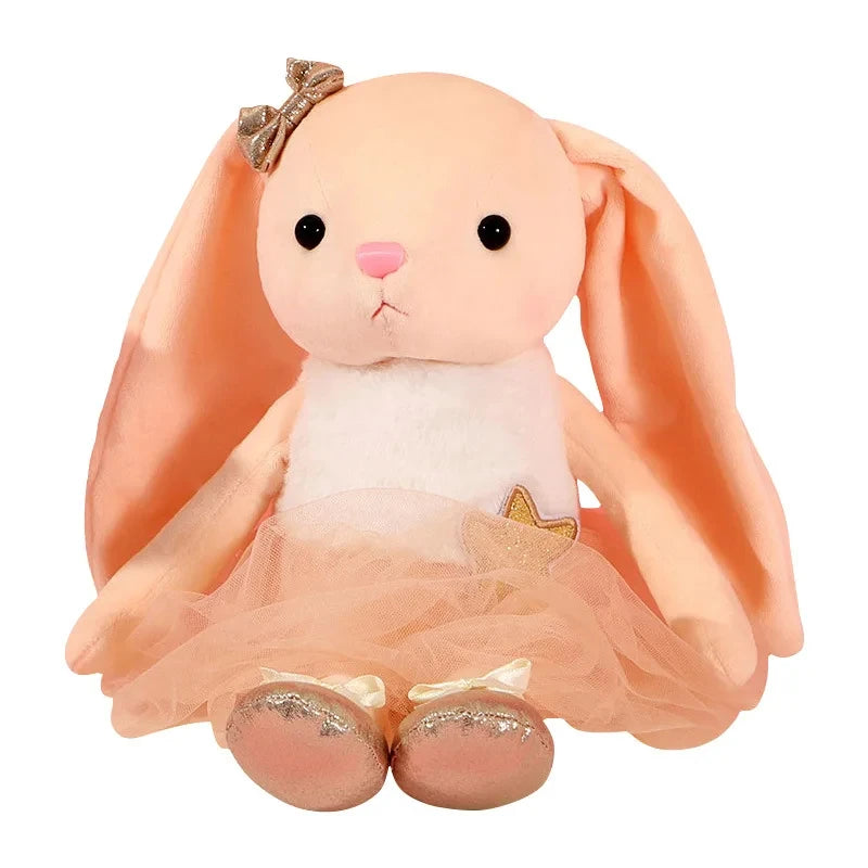 A soft peach-colored plush rabbit toy with large ears and a pink nose.