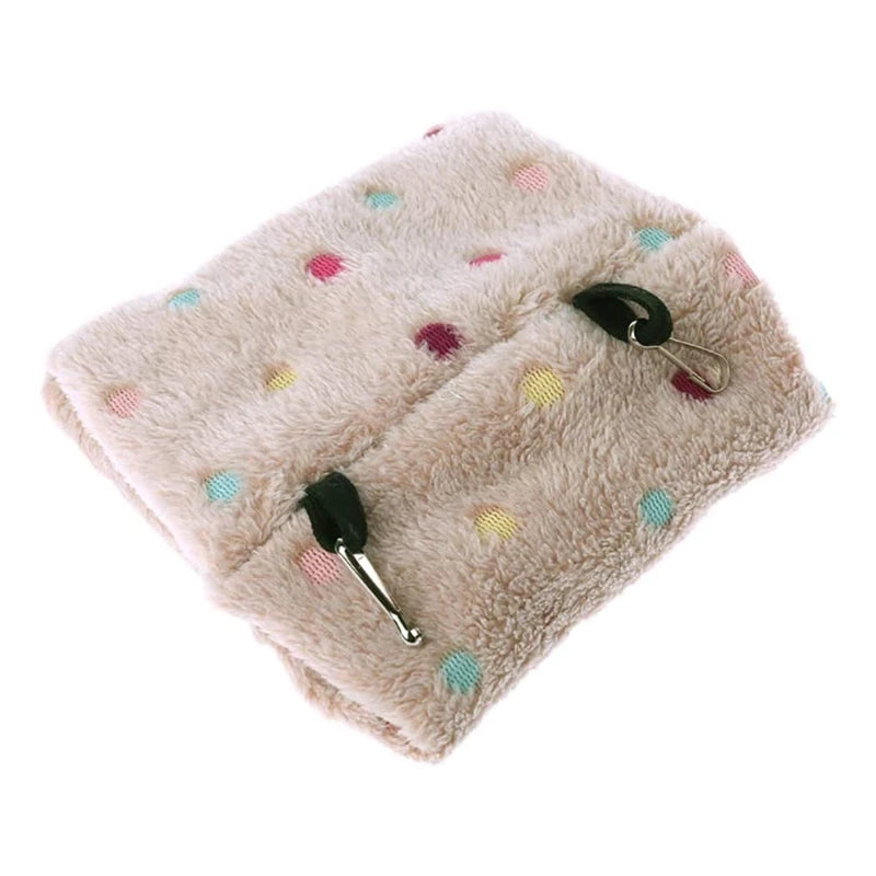 A light beige plush parrot hammock bed with multicolored polka dots and attached hangers.