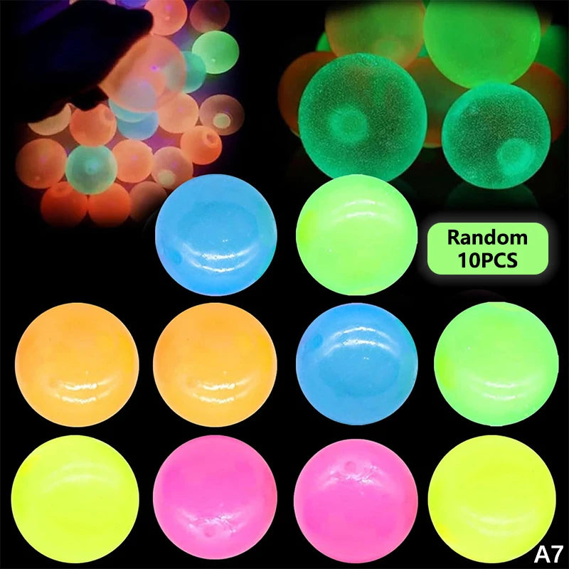 A collection of glow-in-the-dark sticky sensory balls in various colors including green, blue, orange, and pink.