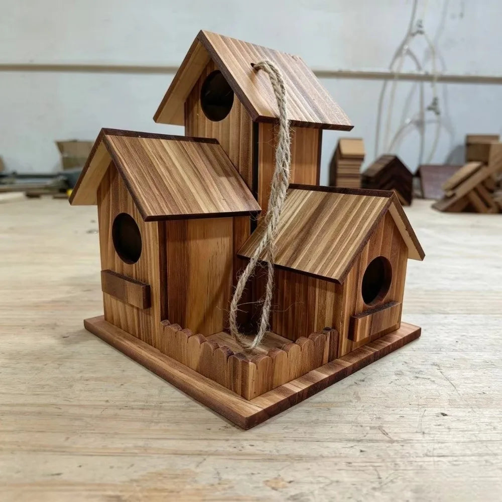 A rustic wooden bird house made of light brown wood with a pitched roof and a natural twine hanging from the entrance.