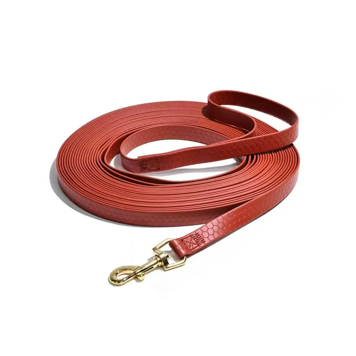A roll of durable waterproof dog leash in a reddish-brown leather material with a rustproof metal hook.