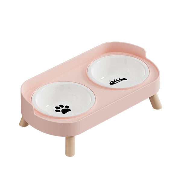 A pink dual pet feeding bowl set with two white bowls and wooden supports.