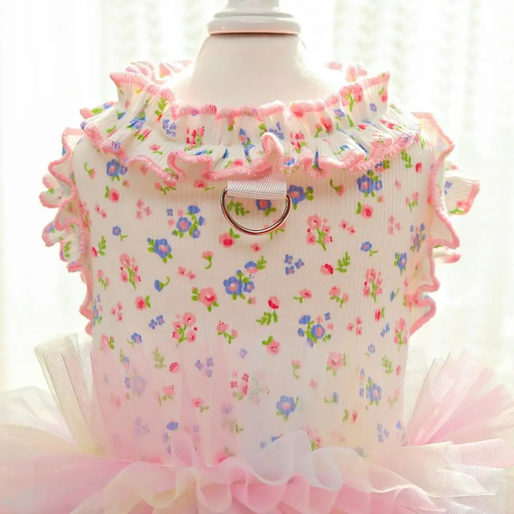 Pink floral vest for dogs and cats displayed on a mannequin with ruffled trim