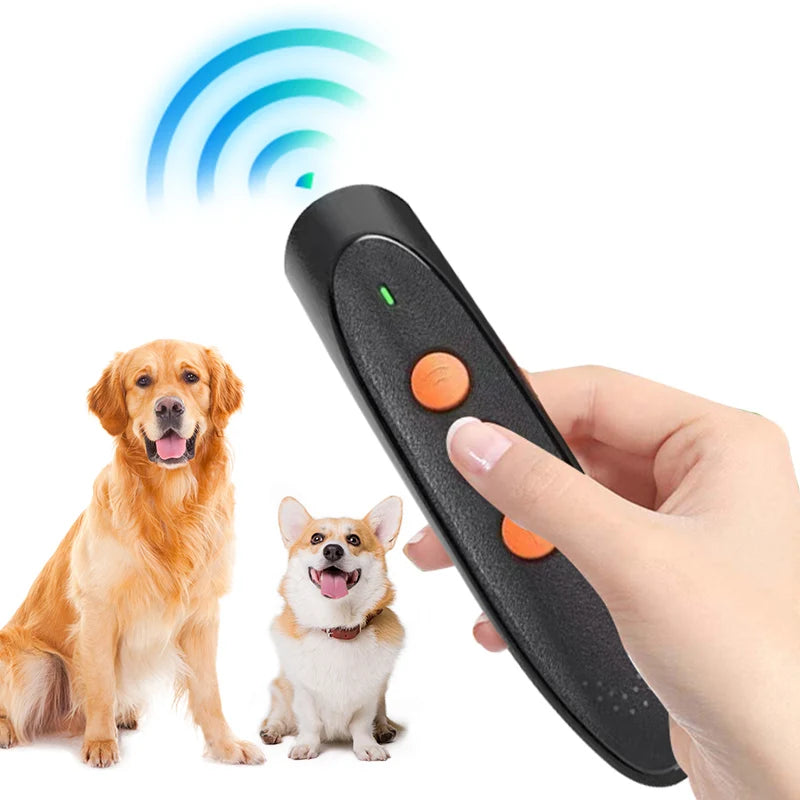 A hand holds a black ultrasonic dog bark deterrent device with an LED light, next to a golden retriever and a small dog.